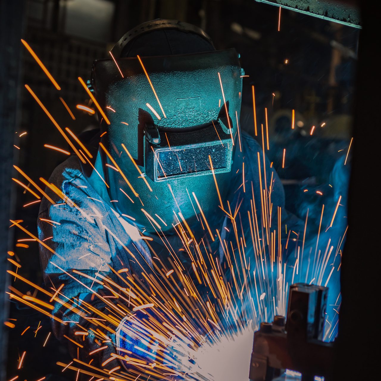 Welder is welding automotive part.