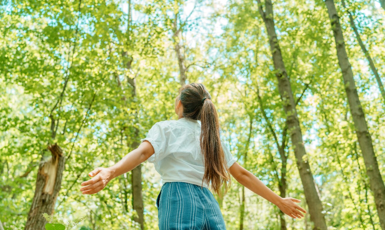 Free woman breathing clean air in nature forest. Happy girl from the back with open arms in happiness. Fresh outdoor woods, wellness healthy lifestyle concept.; Shutterstock ID 1802552131; purchase_order: Diverses; job: ; client: ; other: 