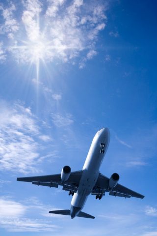 Boeing 767 jet aeroplane landing from bright summer sky. A conceptual look at air travel. More aircraft