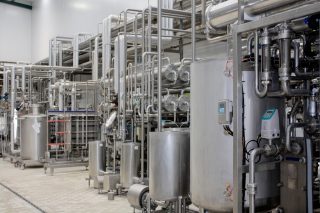 Stock Photography: iStock-164653017_000023475235_Milk Sterilizer.jpg Milk sterilizer machine in a packing plant.